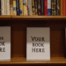 A bookshelf with spaces for new books, labeled with "Your Book Here" placeholders